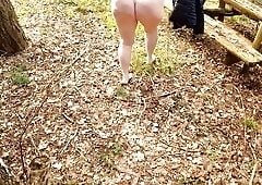 Slapping her naked vagina on table in the woods