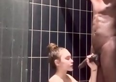 Cum loving milf sucks off big black dick in the shower