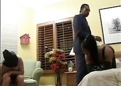 Black chick with big tits gets fucked by guy as she sucks another on the sofa